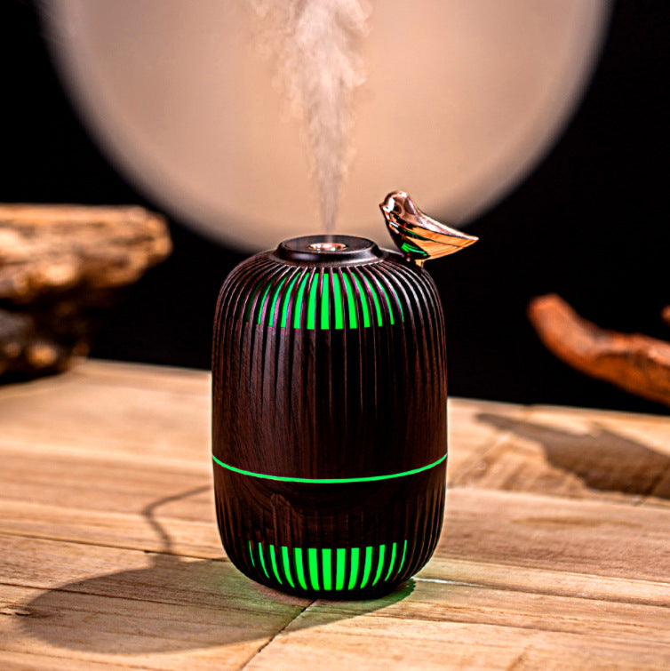 Dreambird Aroma Diffuser in Dark Walnut misting with green light